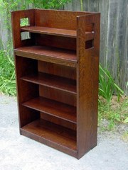 Replica Charles Limbert open bookcase with square cut out design.
